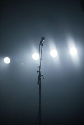 microphone on a stage with lights behind it