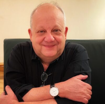 Christopher Long with arms folded in front of him