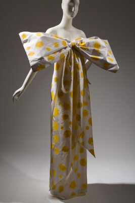 mannequin with polka-dot dress with very large bow across the chest