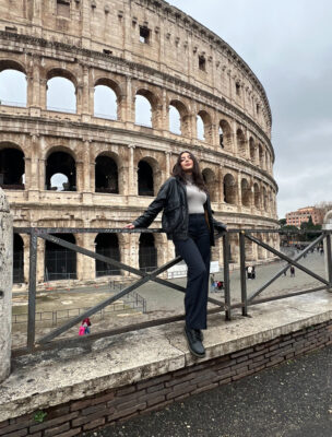 student in front of the Roman Coliseum