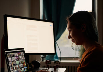 woman sits at a laptop