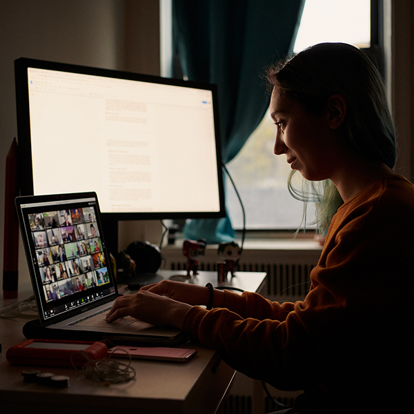 woman sits at a laptop