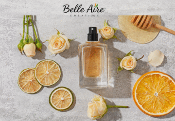 perfume bottle, slices of citrus, honey, rosebuds, and Belle Aire logo