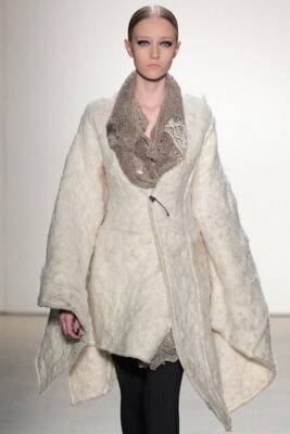 model in a white felted wool coat with natural dyed lace collar