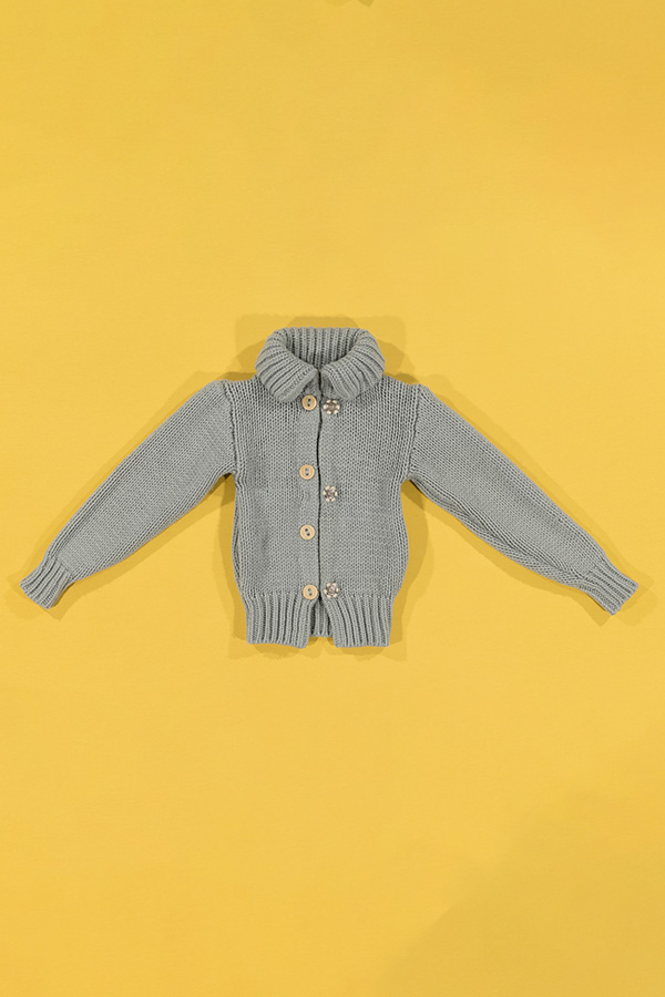 gray-blue cardigan on a yellow background